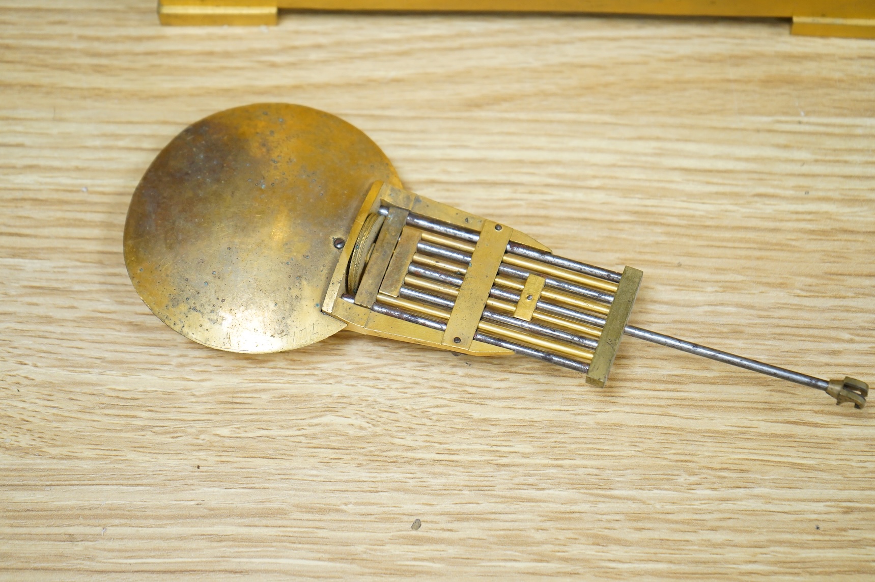 A 19th century French gilt brass eight day portico clock with pendulum, 38cm